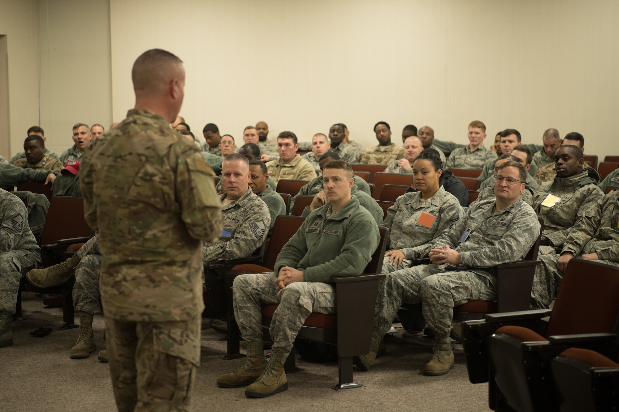 A leader addresses a group of Airmen