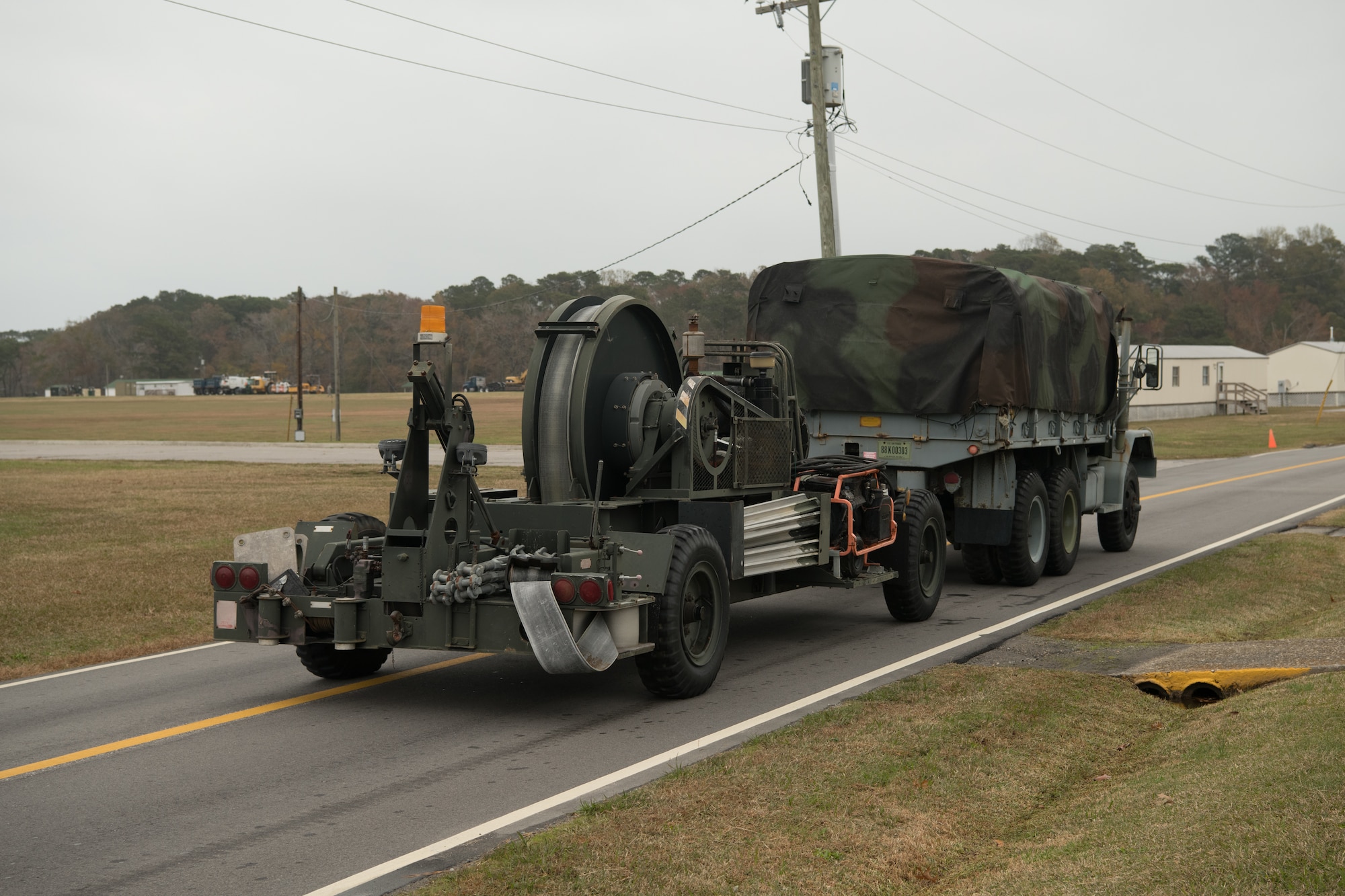 A truck transports part of a mobile aircraft arrest system