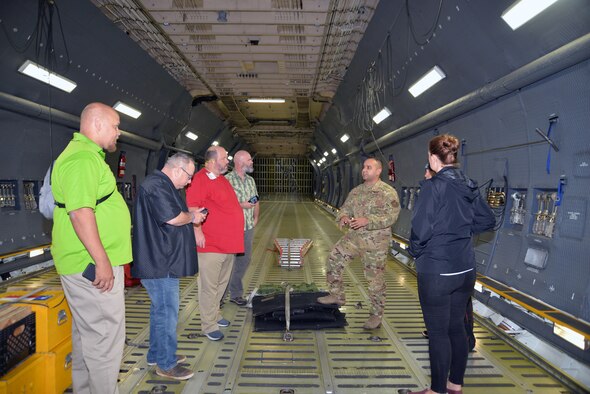 Tech. Sgt. Christian K. Ingle, 356th Airlift Squadron instructor loadmaster, talks to a group of educators about the C-5M Super Galaxy’s cargo carrying capabilities Nov. 7, 2019 at Joint Base San Antonio-Lackland, Texas.