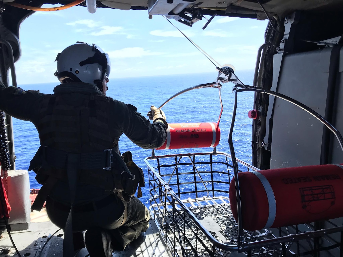 PACIFIC OCEAN (Nov. 20, 2019) Hospital Corpsman 1st Class Patrick Shea prepares to lower a rescue basket used as part of a medical evacuation mission conducted by the "Island Knights" of Helicopter Sea Combat Squadron (HSC) 25. A Chinese national in medical distress aboard the Chinese-flagged vessel Jin Bo was recovered approximately 100 miles northwest of Guam and flown to Guam Memorial Hospital for treatment. HSC-25 provides a multi-mission rotary wing capability for units in the U.S. 7th Fleet area of operations and maintains a Guam-based 24-hour search-and-rescue and medical evacuation capability, directly supporting U.S. Coast Guard and Joint Region Marianas. HSC-25 is the Navy’s only forward-deployed MH-60S expeditionary squadron.