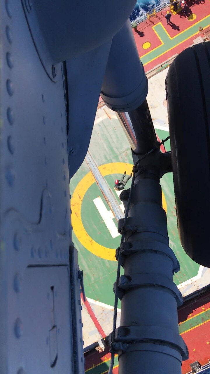 PACIFIC OCEAN (Nov. 20, 2019) Hospital Corpsman 3rd Class Cody Manning, seen between the landing gear and cabin of an MH-60S Sea Hawk helicopter, is raised after assessing a patient during a medical evacuation mission conducted by the "Island Knights" of Helicopter Sea Combat Squadron (HSC) 25. A Chinese national in medical distress aboard the Chinese-flagged vessel Jin Bo approximately 100 miles northwest of Guam was rescued by the Island Knights and transported to Guam Memorial Hospital for treatment. HSC-25 provides a multi-mission rotary wing capability for units in the U.S. 7th Fleet area of operations and maintains a Guam-based 24-hour search-and-rescue and medical evacuation capability, directly supporting U.S. Coast Guard and Joint Region Marianas. HSC-25 is the Navy’s only forward-deployed MH-60S expeditionary squadron.