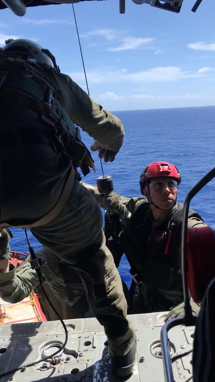 PACIFIC OCEAN (Nov. 20, 2019) Hospital Corpsman 1st Class Patrick Shea (front) lowers Hospital Corpsman 3rd Class Cody Manning (left) and Naval Air Crewman (Helicopter) 3rd Class Alex Aviles (right) in a rescue basket during a medical evacuation mission conducted by the "Island Knights" of Helicopter Sea Combat Squadron (HSC). A Chinese national in medical distress aboard the Chinese-flagged vessel Jin Bo was recovered approximately 100 miles northwest of Guam and flown to Guam Memorial Hospital for treatment. HSC-25 provides a multi-mission rotary wing capability for units in the U.S. 7th Fleet area of operations and maintains a Guam-based 24-hour search-and-rescue and medical evacuation capability, directly supporting U.S. Coast Guard and Joint Region Marianas. HSC-25 is the Navy’s only forward-deployed MH-60S expeditionary squadron.