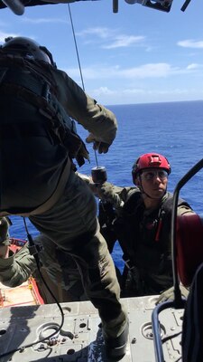 PACIFIC OCEAN (Nov. 20, 2019) Hospital Corpsman 1st Class Patrick Shea (front) lowers Hospital Corpsman 3rd Class Cody Manning (left) and Naval Air Crewman (Helicopter) 3rd Class Alex Aviles (right) in a rescue basket during a medical evacuation mission conducted by the "Island Knights" of Helicopter Sea Combat Squadron (HSC). A Chinese national in medical distress aboard the Chinese-flagged vessel Jin Bo was recovered approximately 100 miles northwest of Guam and flown to Guam Memorial Hospital for treatment. HSC-25 provides a multi-mission rotary wing capability for units in the U.S. 7th Fleet area of operations and maintains a Guam-based 24-hour search-and-rescue and medical evacuation capability, directly supporting U.S. Coast Guard and Joint Region Marianas. HSC-25 is the Navy’s only forward-deployed MH-60S expeditionary squadron.
