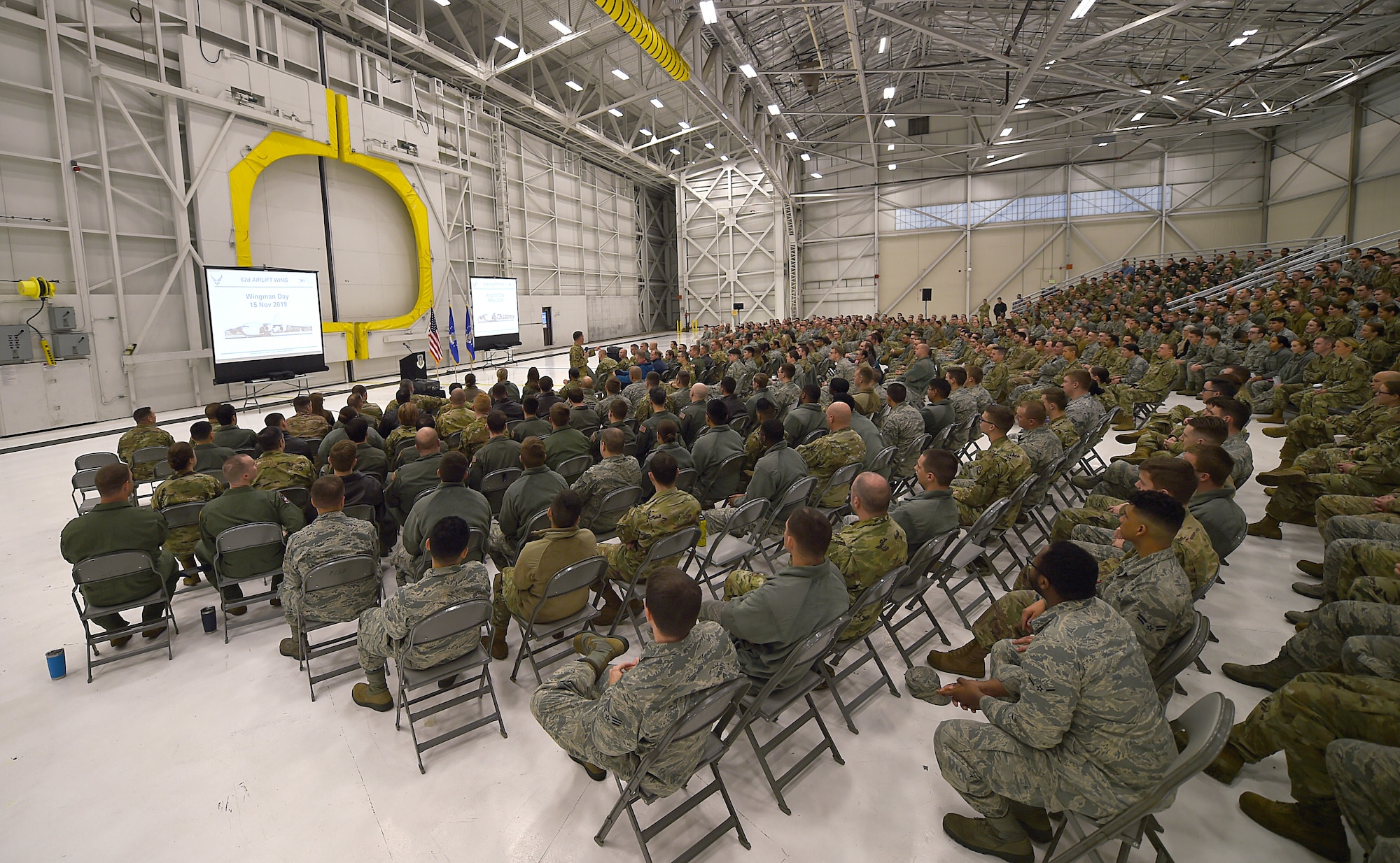 Members of the 62nd Airlift Wing gather in a hanger for a commander’s all-call on Joint Base Lewis-McChord, Wash., Nov. 15, 2019. The all-call was an opportunity for Col. Scovill Currin, 62nd Airlift Wing commander, and Chief Master Sgt. Rob Schultz, 62nd Airlift Wing command chief, to address the wing en masse.