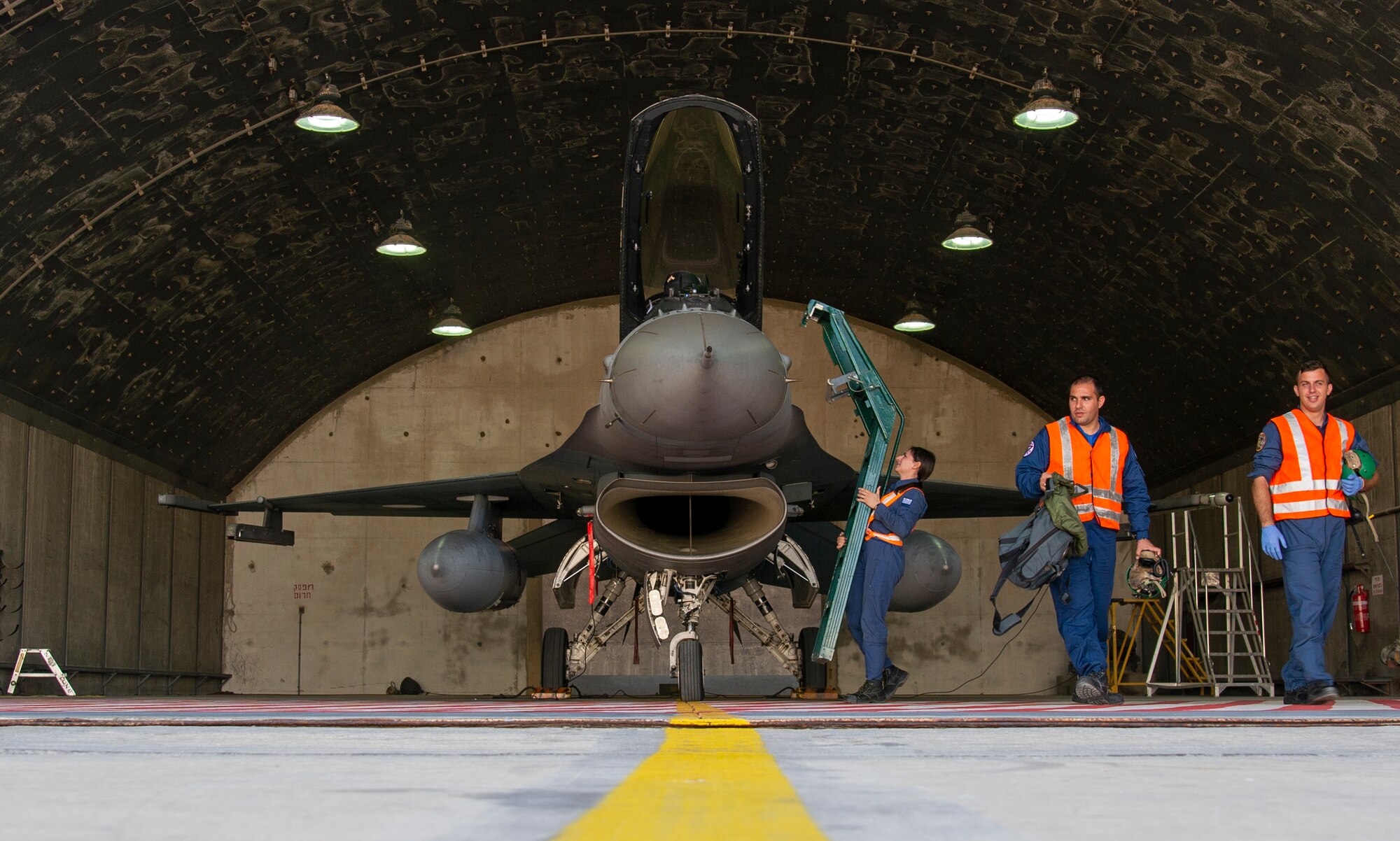 Hellenic service members from the 335th Fighter Squadron prepare an F-16 Fighting Falcon for take off during Blue Flag 2019 at Uvda Air Base, Israel, November 7, 2019. The three member team worked together to prepare the F-16 for participation in the day's training exercises. (U.S. Air Force photo by Airman 1st Class Kyle Cope)