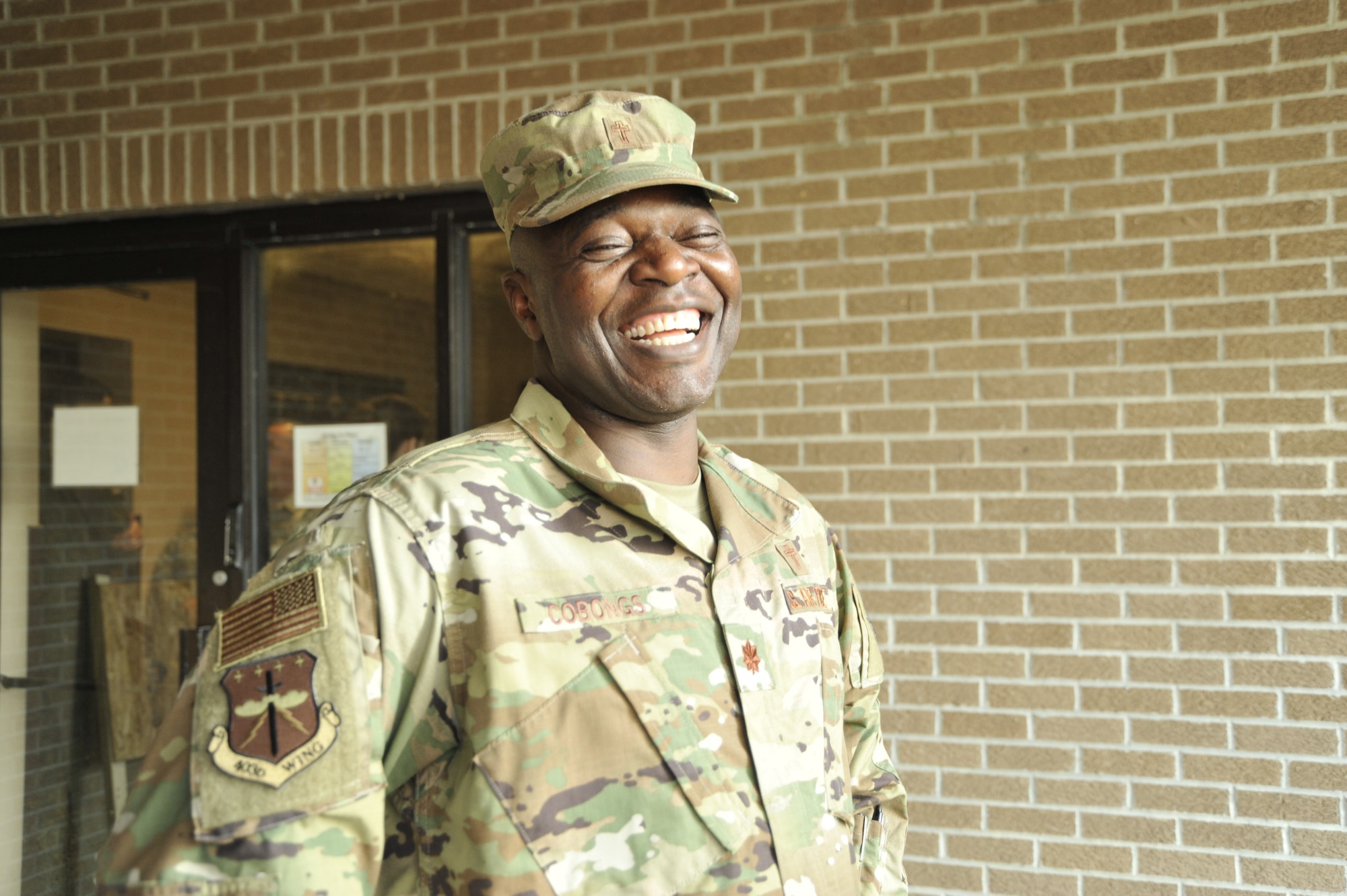 Major Bitrus B. Cobongs, 403rd Wing Chaplain smiles as he prepares to attend a 403rd Wing Staff meeting, Oct. 5, 2019 at Keesler Air Force Base, Miss. Cobongs advises leadership on religious and spiritual matters, moral welfare, conducts unit ministry, counseling, and pastoral care for the Reserve Citizen Airmen of 403rd Wing. (U.S. Air Force photo by TSgt. Michael Farrar)