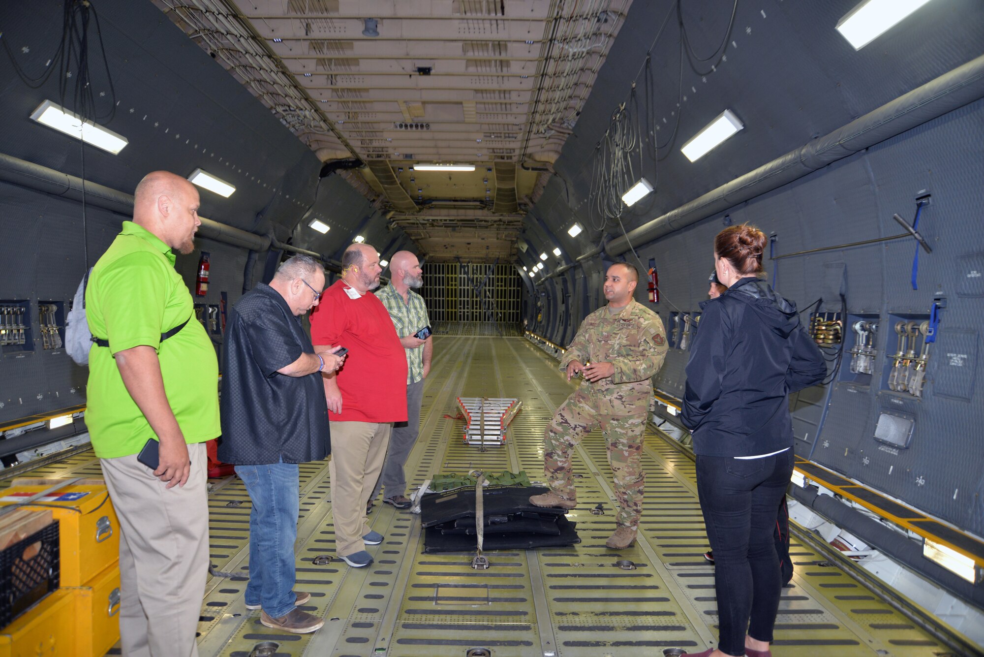 Tech. Sgt. Christian K. Ingle, 356th Airlift Squadron instructor loadmaster, talks to a group of educators about the C-5M Super Galaxy’s cargo carrying capabilities Nov. 7, 2019 at Joint Base San Antonio-Lackland, Texas.