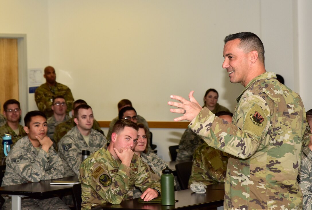 A photo of Chief Master Sgt. Trey Walker, 480th Intelligence, Surveillance and Reconnaissance Wing command chief, talking with Airmen at an NCO all call