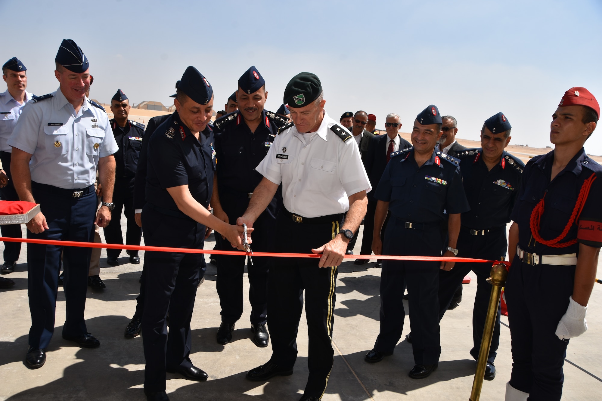 A ribbon cutting ceremony at Cairo West Air Base, marking the completion of a $184 million construction project and delivery of 20 F-16s. U.S. Air Force Brig. Gen Brian Bruckbauer (left), director of the Air Force Security Assistance and Cooperation Directorate, and U.S. Army Maj. Gen. Ralph Groover III (middle right) the Senior Defense Official, United States Embassy, Cairo Egypt, attended the event.