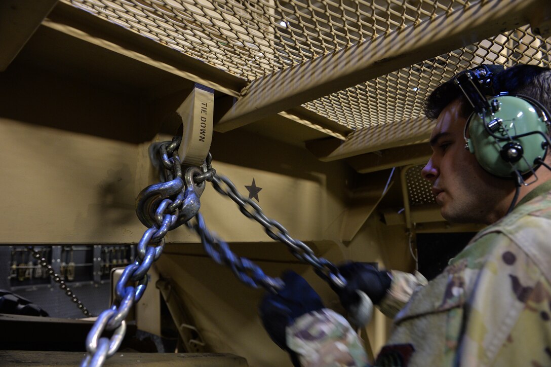 U.S. Air Force Aerial Transportation Specialists with the 378th Aerial Expeditionary Squadron unchain a patriot launching station from a C-5  Galaxy at Prince Sultan Air Base (PSAB), Kingdom of Saudi Arabia (KSA), October 23, 2109.