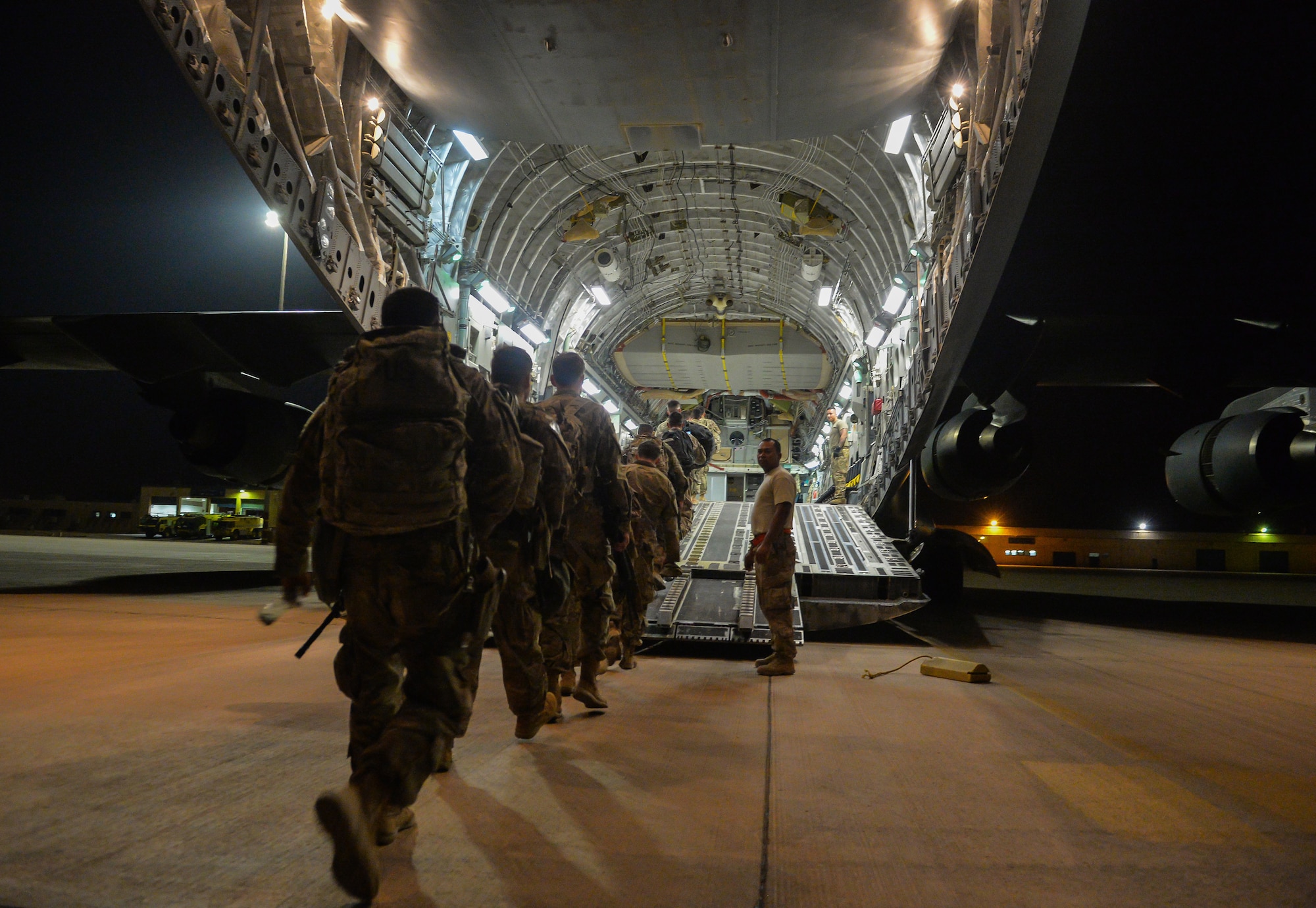 U.S. Army Soldiers with the 4th Infantry Division walk onto a C-17 Globemaster III at Prince Sultan Air Base (PSAB), Kingdom of Saudi Arabia (KSA), October 23, 2109.