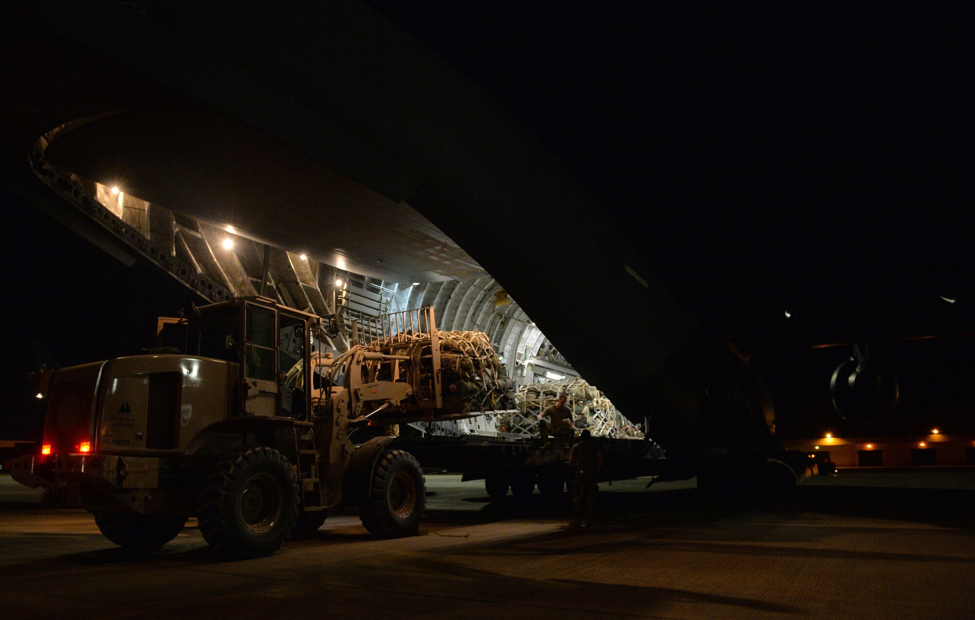 U.S. Air Force Aerial Transportation Specialists with the 378th Aerial Expeditionary Squadron, unload cargo from the back of a C-17 Globemaster III arriving at Prince Sultan Air Base (PSAB), Kingdom of Saudi Arabia (KSA), October 23, 2109.