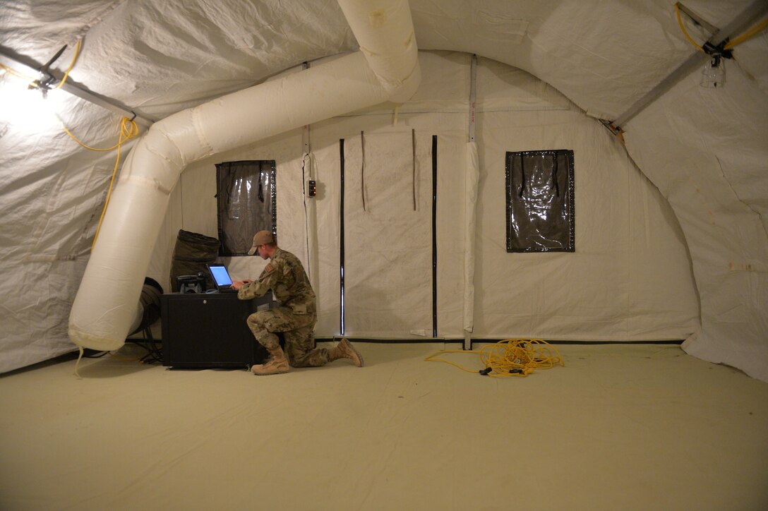 U.S. Air Force Airman 1st Class Tyler Kenyon, 5th Combat Communications, Cyber Transport Technician, programs a non-classified internet protocol router network computer, at Prince Sultan Air Base (PSAB), Kingdom of Saudi Arabia (KSA), October 17, 2019.