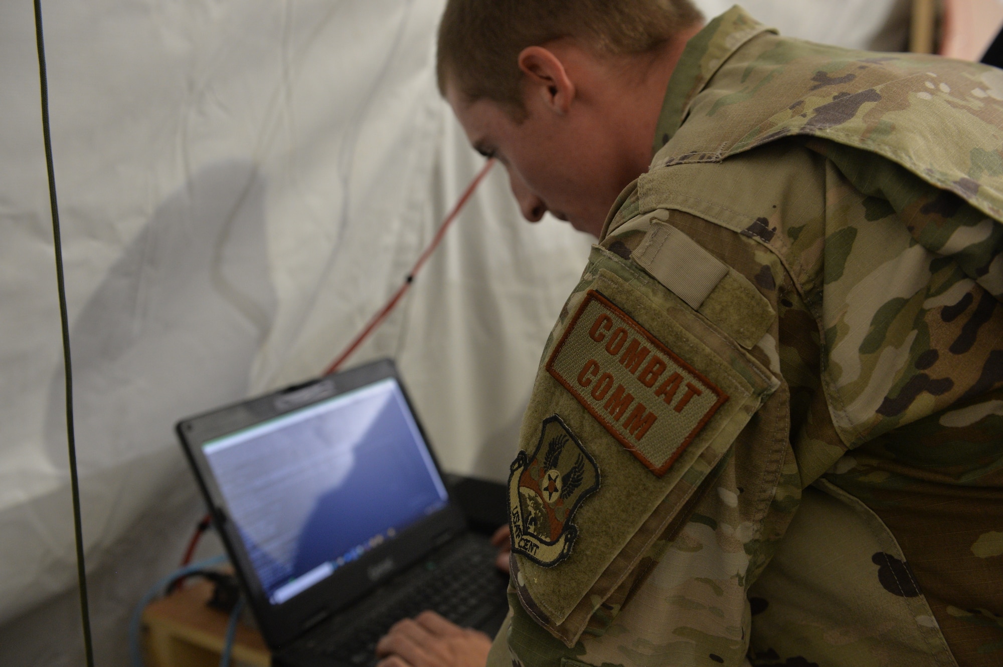 U.S. Air Force Airman 1st Class Tyler Kenyon, 5th Combat Communications, Cyber Transport Technician, programs a non-classified internet protocol router network computer, at Prince Sultan Air Base (PSAB), Kingdom of Saudi Arabia (KSA), October 17, 2019.