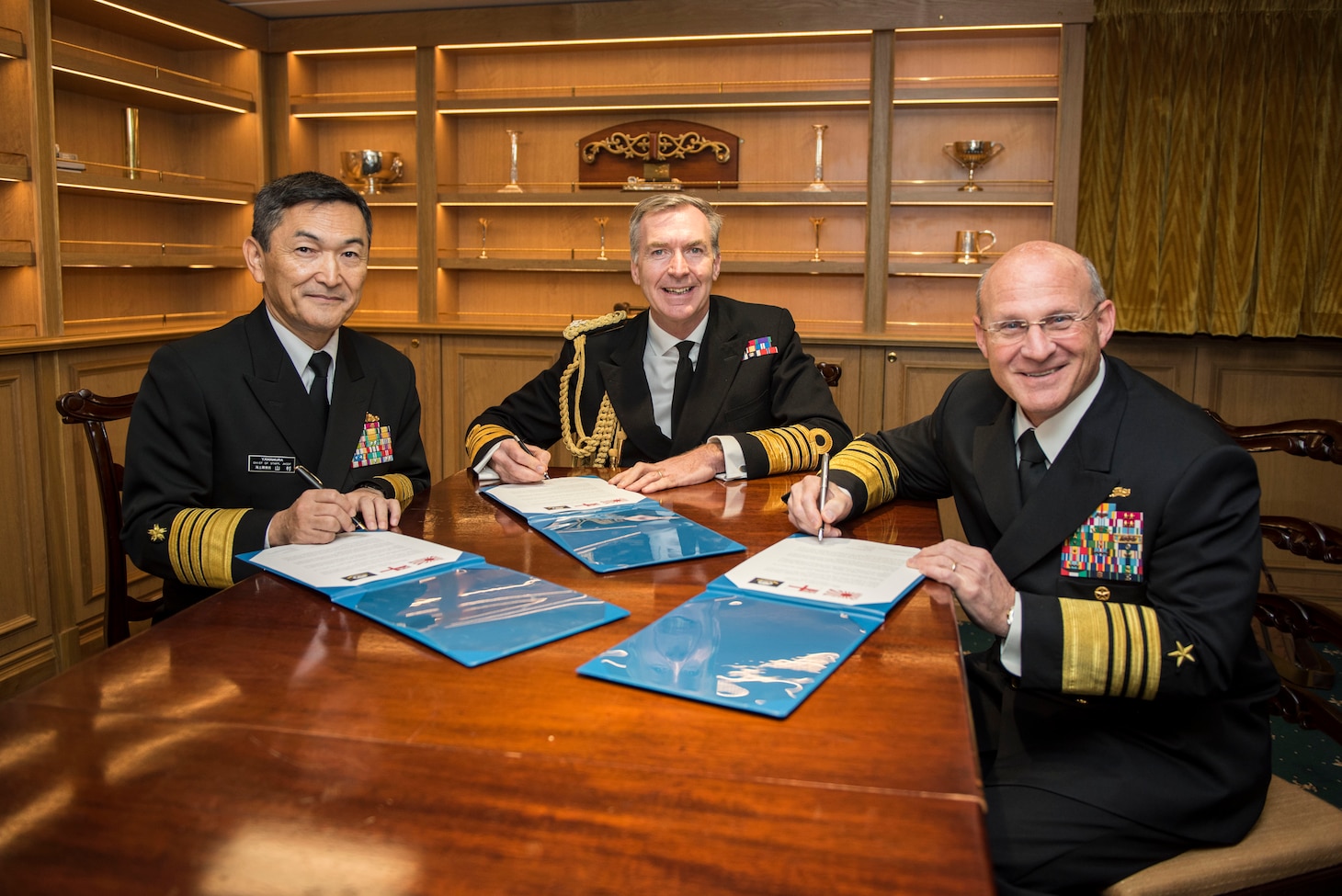 ANNAPOLIS, Md. (Nov. 20, 2019) Chief of Maritime Staff Adm. Hiroshi Yamamura, left, First Sea Lord Adm. Tony Radakin, and Chief of Naval Operations (CNO) Adm. Mike Gilday sign a Trilateral Head of Navy Joint Statement aboard the Royal Navy aircraft carrier HMS Queen Elizabeth (R08). The trilateral cooperation agreement reaffirms the three countries’ commitment to increased collaboration and cooperation.
