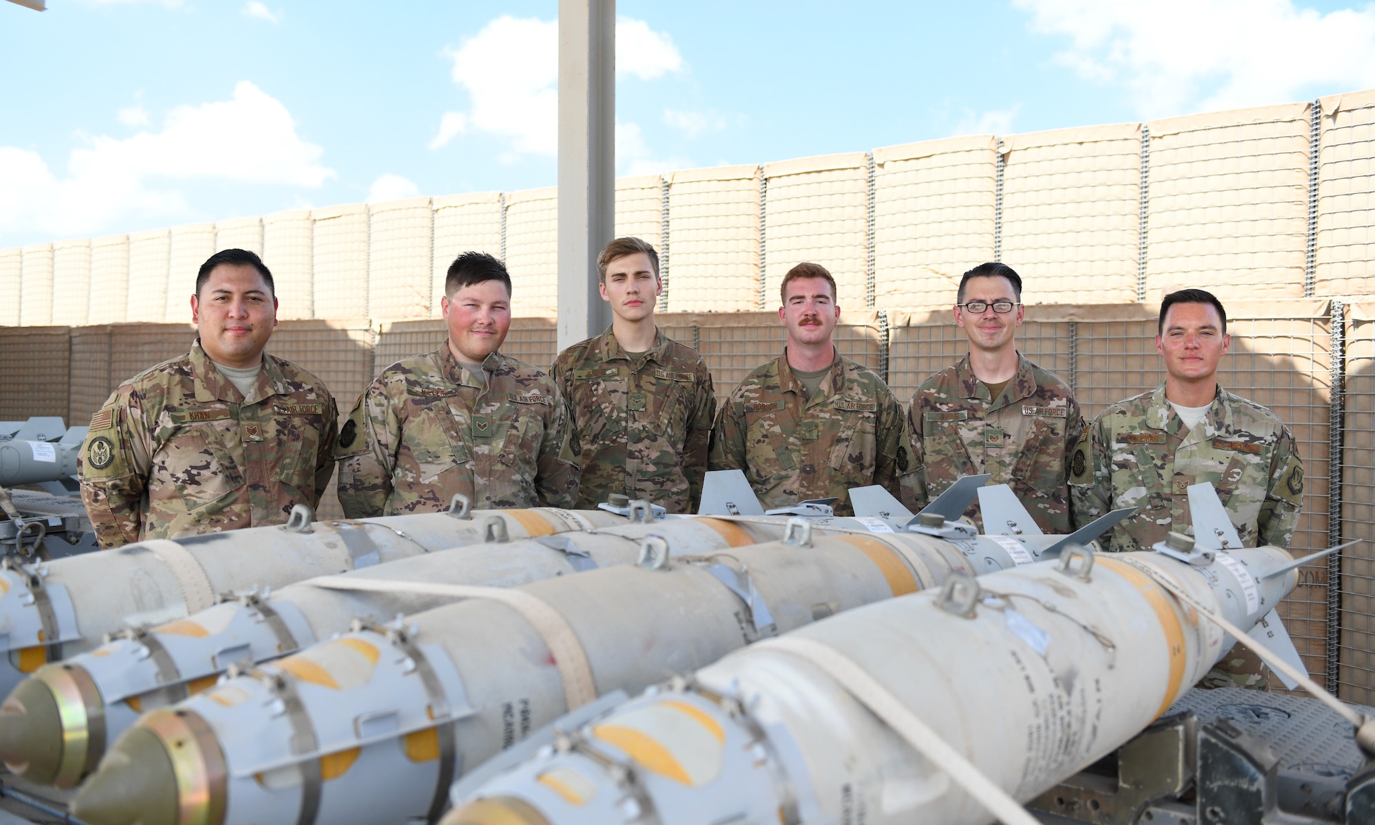 U.S. Air Force munitions Airmen assigned to the 726th Expeditionary Air Base Squadron pose for a photo after a bomb build at Chabelley Airfield, Djibouti, Nov. 12, 2019. The 726th EABS Munitions Systems Airmen build, inspect and store all munitions at the airfield, ensuring mission effectiveness at a moment’s notice. (U.S. Air Force photo by Staff Sgt. Alex Fox Echols III)