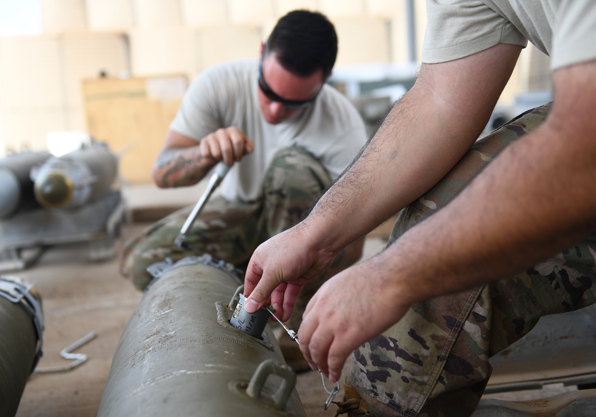 U.S. Air Force munitions Airmen assigned to the 726th Expeditionary Air Base Squadron assemble munitions during a bomb build at Chabelley Airfield, Djibouti, Nov. 12, 2019. The 726th EABS Munitions Systems Airmen build, inspect and store all munitions at the airfield, ensuring mission effectiveness at a moment’s notice. (U.S. Air Force photo by Staff Sgt. Alex Fox Echols III)