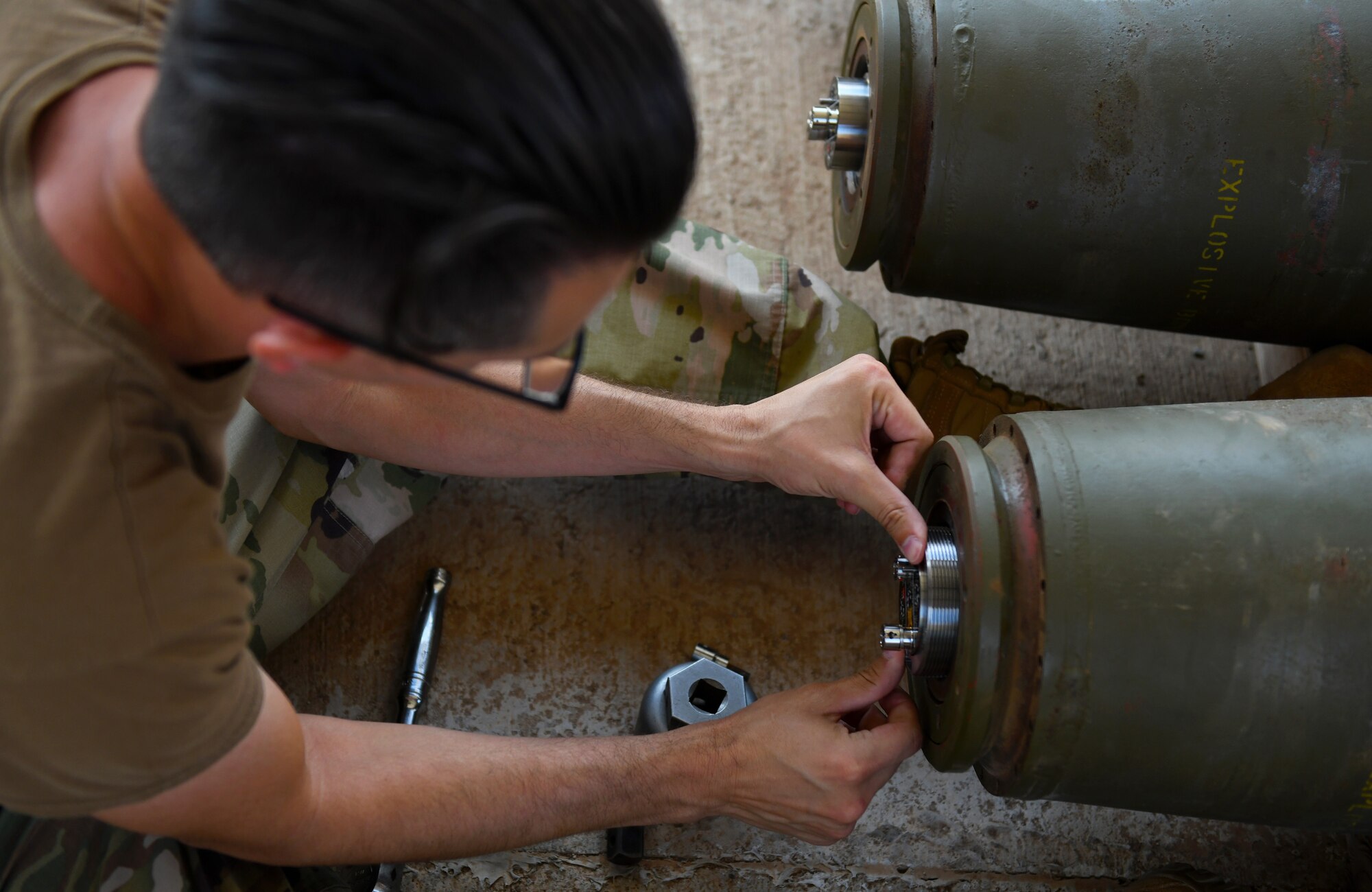 U.S. Air Force Tech. Sgt. Brandon Coleman, 726th Expeditionary Air Base Squadron munitions production supervisor, installs a fuse assembly during a bomb build at Chabelley Airfield, Djibouti, Nov. 12, 2019. The 726th EABS Munitions Systems Airmen build, inspect and store all munitions at the airfield, ensuring mission effectiveness at a moment’s notice. (U.S. Air Force photo by Staff Sgt. Alex Fox Echols III)