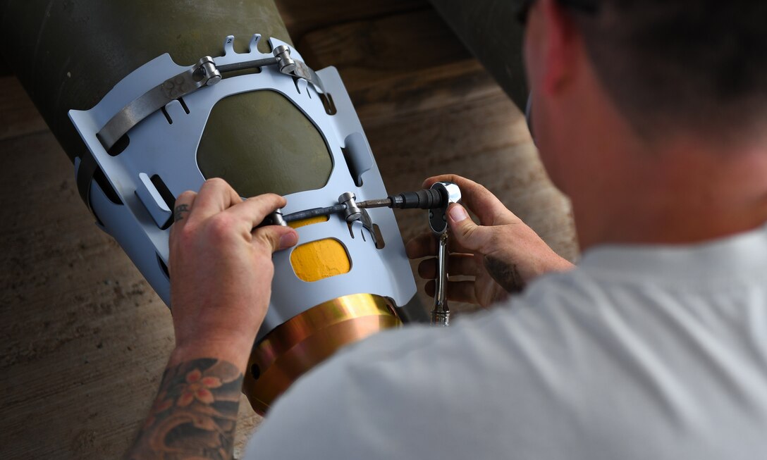 U.S. Air Force Tech. Sgt. Brandon Coleman, 726th Expeditionary Air Base Squadron senior munitions inspector, assembles the nose of munitions during a bomb build at Chabelley Airfield, Djibouti, Nov. 12, 2019. The 726th EABS Munitions Systems Airmen build, inspect and store all munitions at the airfield, ensuring mission effectiveness at a moment’s notice. (U.S. Air Force photo by Staff Sgt. Alex Fox Echols III)