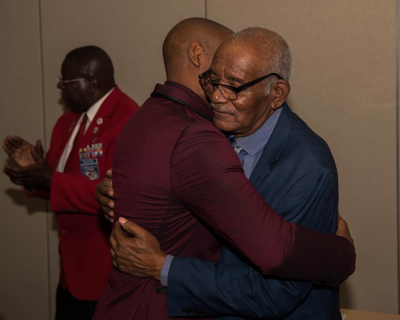 Retired U.S. Air Force Tech. Sgt. Stevie Carmack embraces his father U.S. Army Air Forces Sgt. Thomas Newton during a recognition ceremony in Hampton, Virginia, Nov. 13, 2019. Carmack was instrumental in gathering the documentation necessary to have his father certified as a Documented Original Tuskegee Airman (DOTA). (U.S. Air Force photo by Airman 1st Class Marcus M. Bullock)