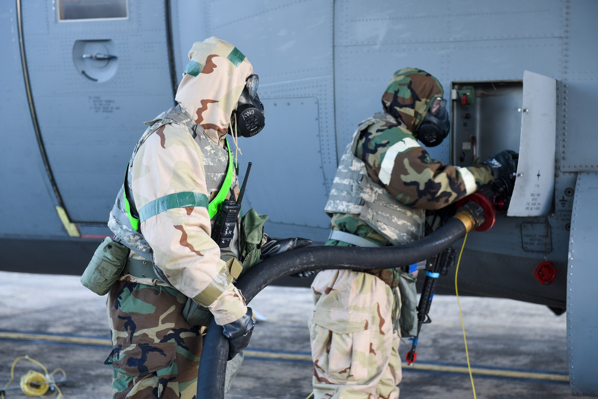 Airmen fill gas in a C-130J aircraft