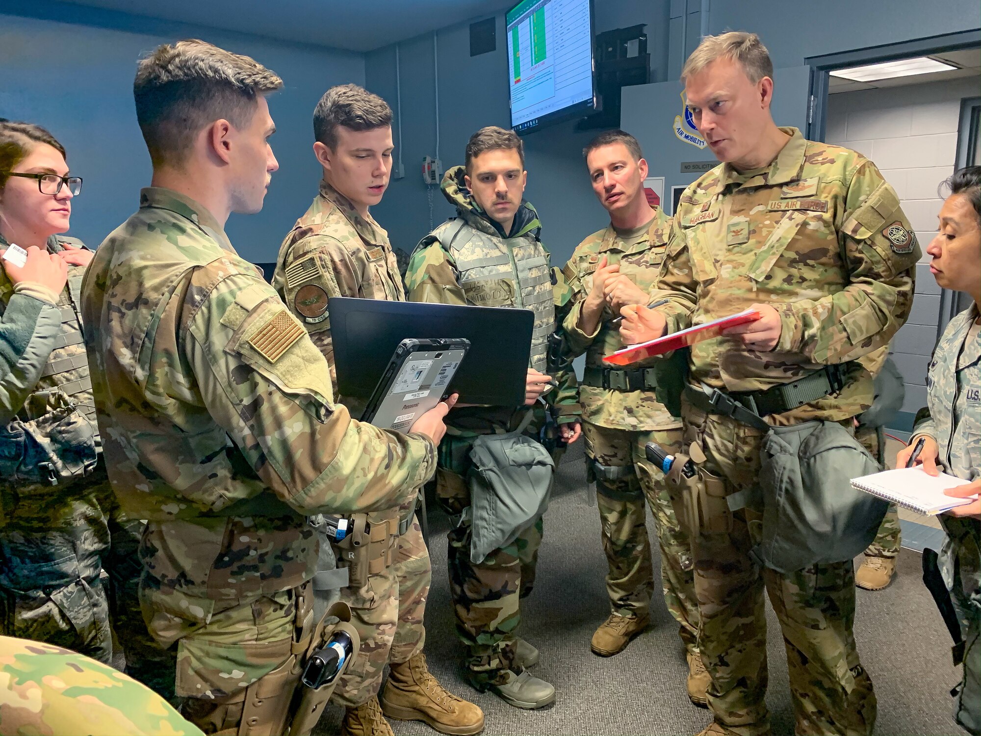 airmen stand during briefing