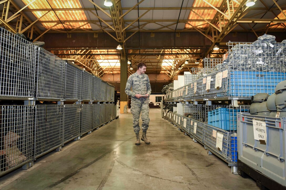 U.S. Air Force Senior Airman Ronald Tedder, 39th Logistics Readiness Squadron individual protective equipment specialist, inspects protective gear at the base supply warehouse Nov. 18, 2019, at Incirlik Air Base, Turkey. IPE Airmen manage, store and track inventories of protective gear at the base supply warehouse. (U.S. Air Force photo by Staff Sgt. Joshua Magbanua)