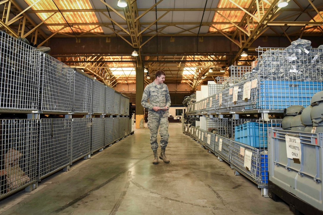 U.S. Air Force Senior Airman Ronald Tedder, 39th Logistics Readiness Squadron individual protective equipment specialist, inspects protective gear at the base supply warehouse Nov. 18, 2019, at Incirlik Air Base, Turkey. IPE Airmen manage, store and track inventories of protective gear at the base supply warehouse. (U.S. Air Force photo by Staff Sgt. Joshua Magbanua)