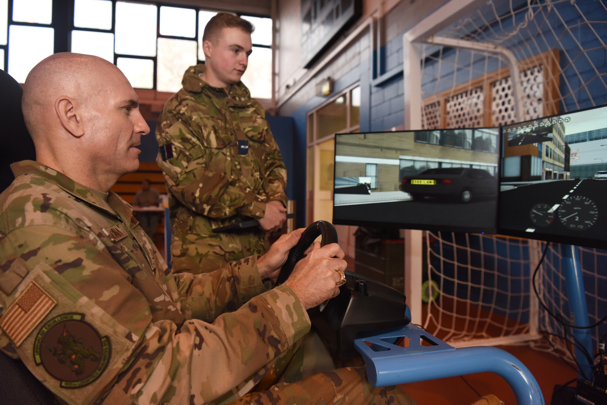 Major Anthony Lamagna, 100th Logistics Readiness Squadron commander, operates a road safety simulator during a Road Safety Day event at RAF Mildenhall, England, Nov. 21, 2019. UK Road Safety Week runs Nov. 18 – 24 and aims to inspire people in the UK to take action on road safety and promote life-saving messages. (U.S. Air Force photo by Senior Airman Brandon Esau)
