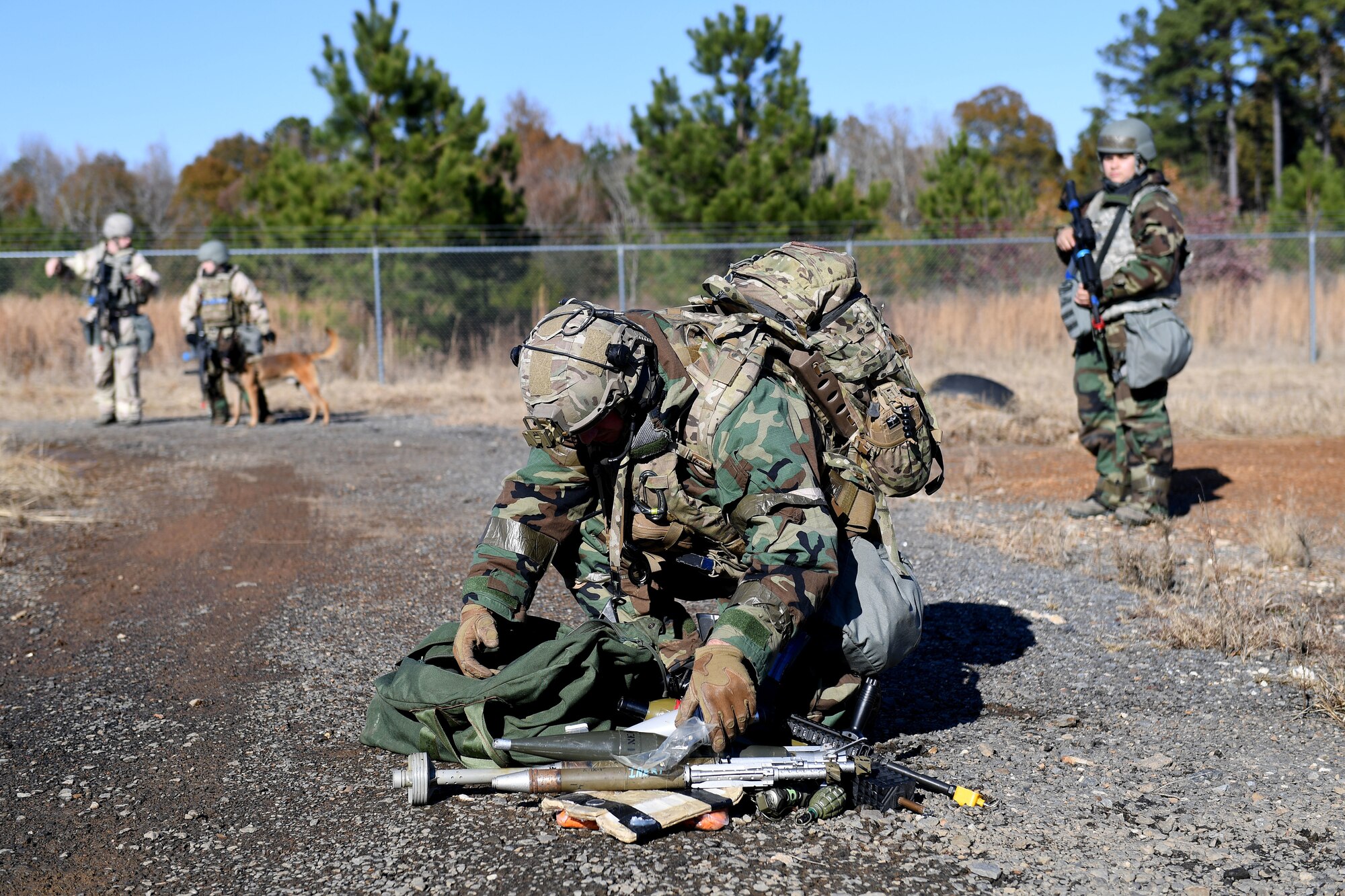 An Airman collects a weapons cache