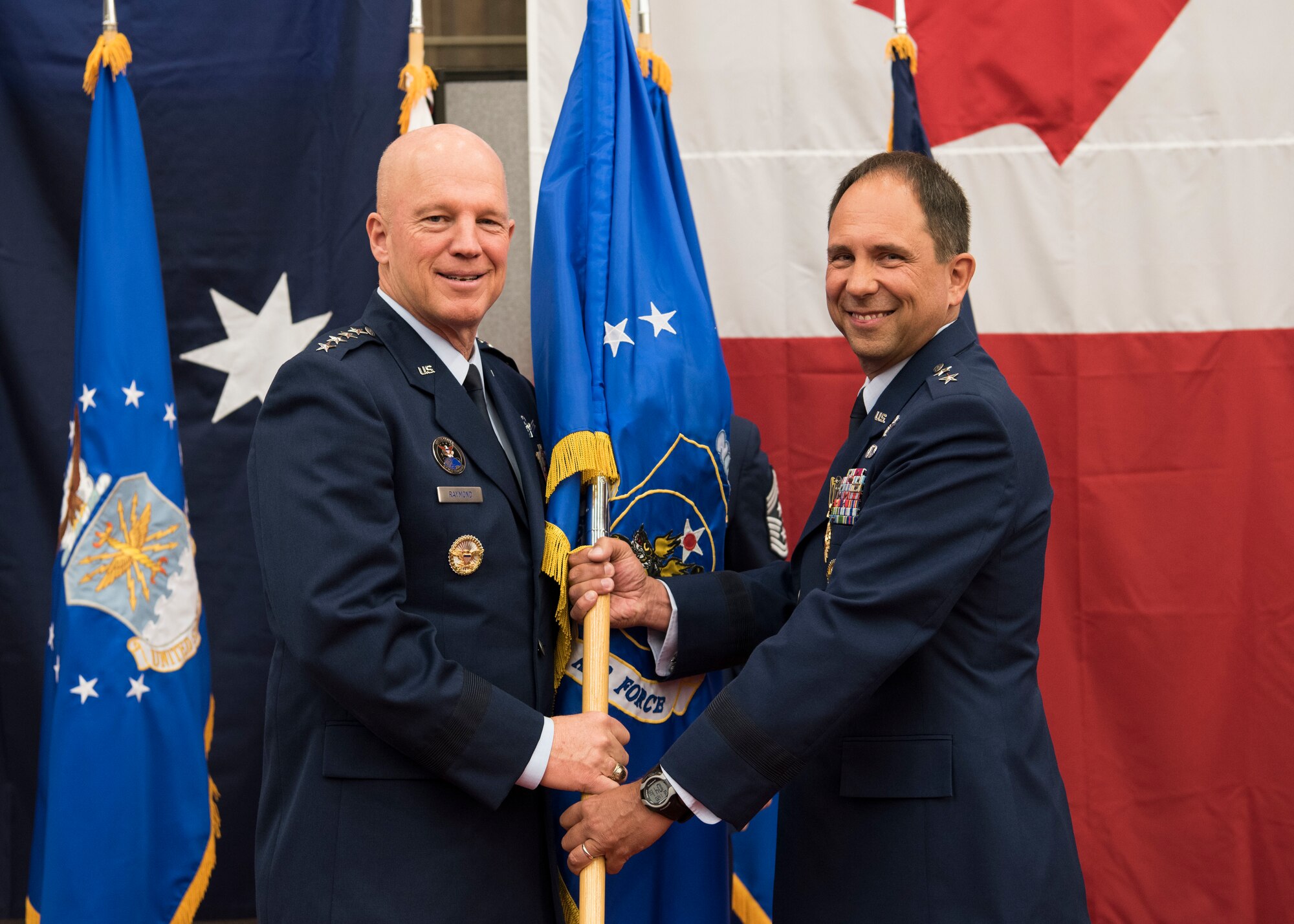 Gen. John W. “Jay” Raymond, U.S. Space Command and Air Force Space Command commander, presents the 14th Air Force guidon to Maj. Gen. John. E. Shaw, Combined Force Space Component Command and 14th AF commander, during a change of commander ceremony Nov. 20, 2019, at Vandenberg Air Force Base, Calif. As the Air Force's sole numbered Air Force for space, 14th AF is responsible for the organization, training, equipping, command and control and employment of Air Force space forces to support operational plans and missions for U.S. combatant commanders and air component commanders. (U.S. Air Force photo by Airman 1st Class Aubree Milks)