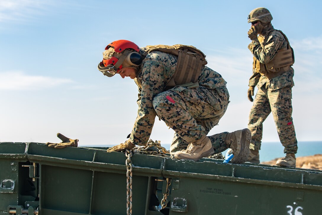 U.S. Marines with Bridge Company, 7th Engineer Support Battalion, build a medium-girder bridge.