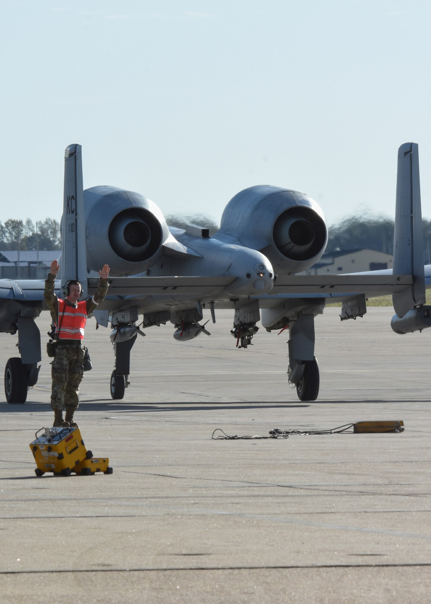 Senior Airman Kyle Jans, an avionics technician with the 442d Aircraft Maintenance Squadron specialist flight, signals a A-10 Thunderbolt II forward at Whiteman Air Force Base, Mo., Nov. 3, 2019. Before the aircraft can take off, the technicians test the radar warning receiving pits to ensure the missile warning capabilities on the aircraft are working properly.