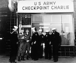 During Berlin Crisis of 1961, group of U.S. Naval Reservists talk to U.S. Army Soldiers who man Checkpoint Charlie, only American checkpoint along Berlin Wall (U.S. Navy Museum)