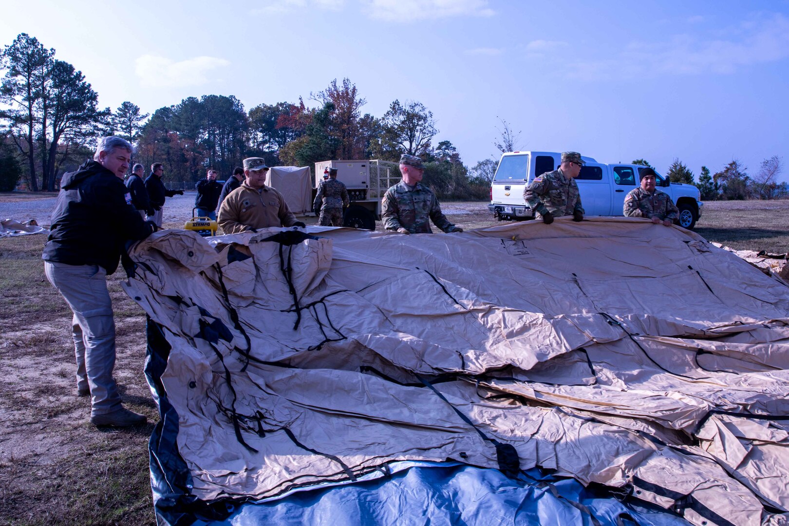 Members of the Joint Task Force Civil Support (JTG-CS) Early-Entry Command Post (EECP) deploys a Drash Air Beam shelter during a communications exercise (COMMEX) at Joint Base Langley-Eustis. The exercise allowed JTF-CS to test the EECP's ability to quickly deploy and utilize the command's equipment and collaborative tools in response to a catastrophic event. (Official DoD photo by Mass Communication Specialist 3rd Class Michael Redd/RELEASED)