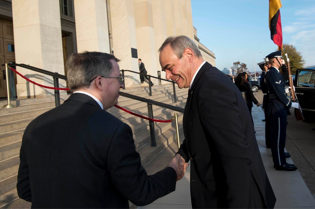Deputy Defense Secretary David L. Norquist greets a man outside the Pentagon.