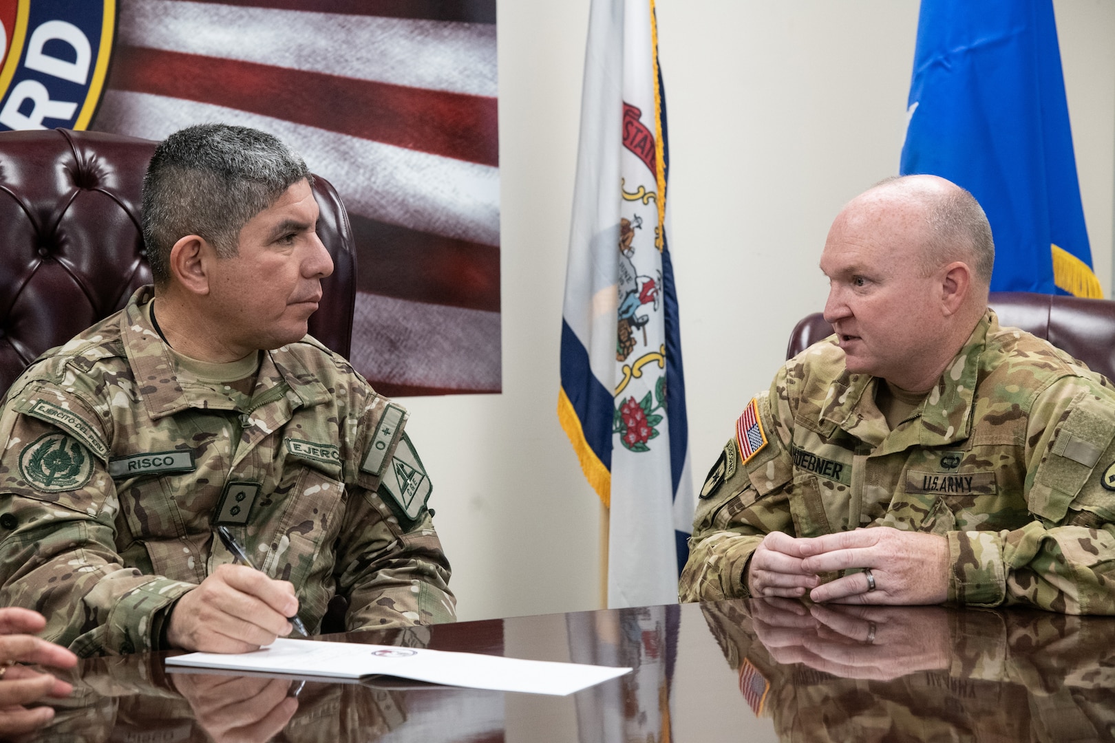 Army Col. Kermit D. Huebner, West Virginia Army National Guard flight surgeon, briefs Maj. Gen. Mario E. Risco Carmen, defense and military attaché to the Embassy of Peru in Washington, D.C., on Army aviation medicine during a State Partnership Program (SPP) visit at Joint Force Headquarters, Charleston, W.Va., Nov. 12, 2019.