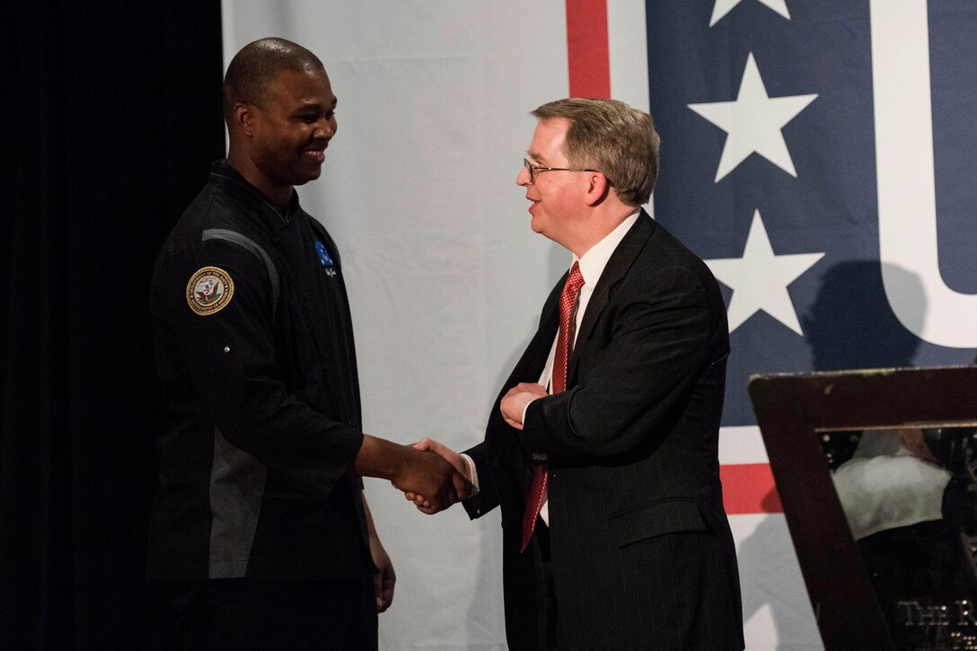 Deputy Defense Secretary David L. Norquist shakes hands with a chef.