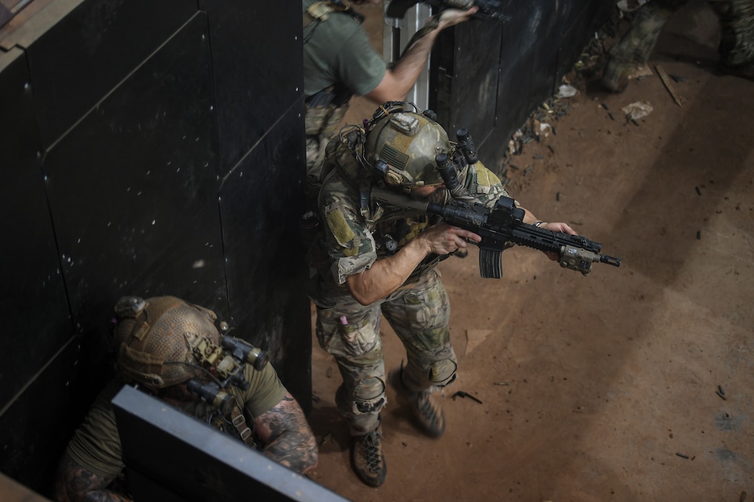 Special ops airmen charge onto room.