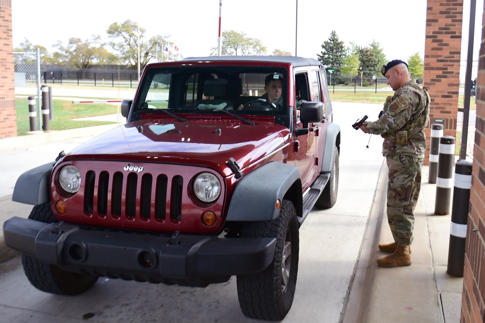 Staff Sgt. Henry Camacho, 434th Security Forces Squadron, checks ID cards of incoming drivers at Grissom Air Reserve Base, Ind., Nov. 3, 2019.  Defenders of the gate perform ID inspection, random vehicle inspections and other law enforcement duties.  (U.S. Air Force photo by Staff Sgt. Chris Massey)