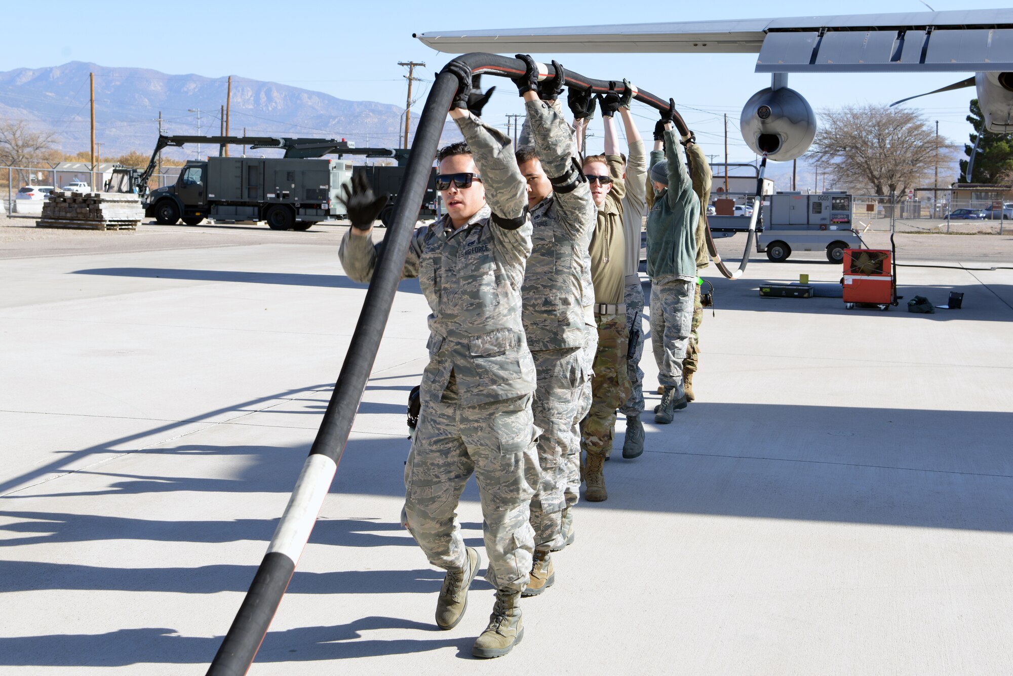 U.S. Air Force Airmen from the 415th Aircraft Maintenance Unit, drain fuel from the inflight refueling pod on a HC-130J Combat King II on the flight line at Kirtland Air Force Base, N.M., Nov. 14, 2019.  The 415th AMU is responsible for all maintenance on the MC-130J Commando II and HC-130J Combat King II aircraft assigned to keep them mission ready for the 415th Special Operation Squadron. (U.S. Air Force photo by Staff Sgt. Dylan Nuckolls)