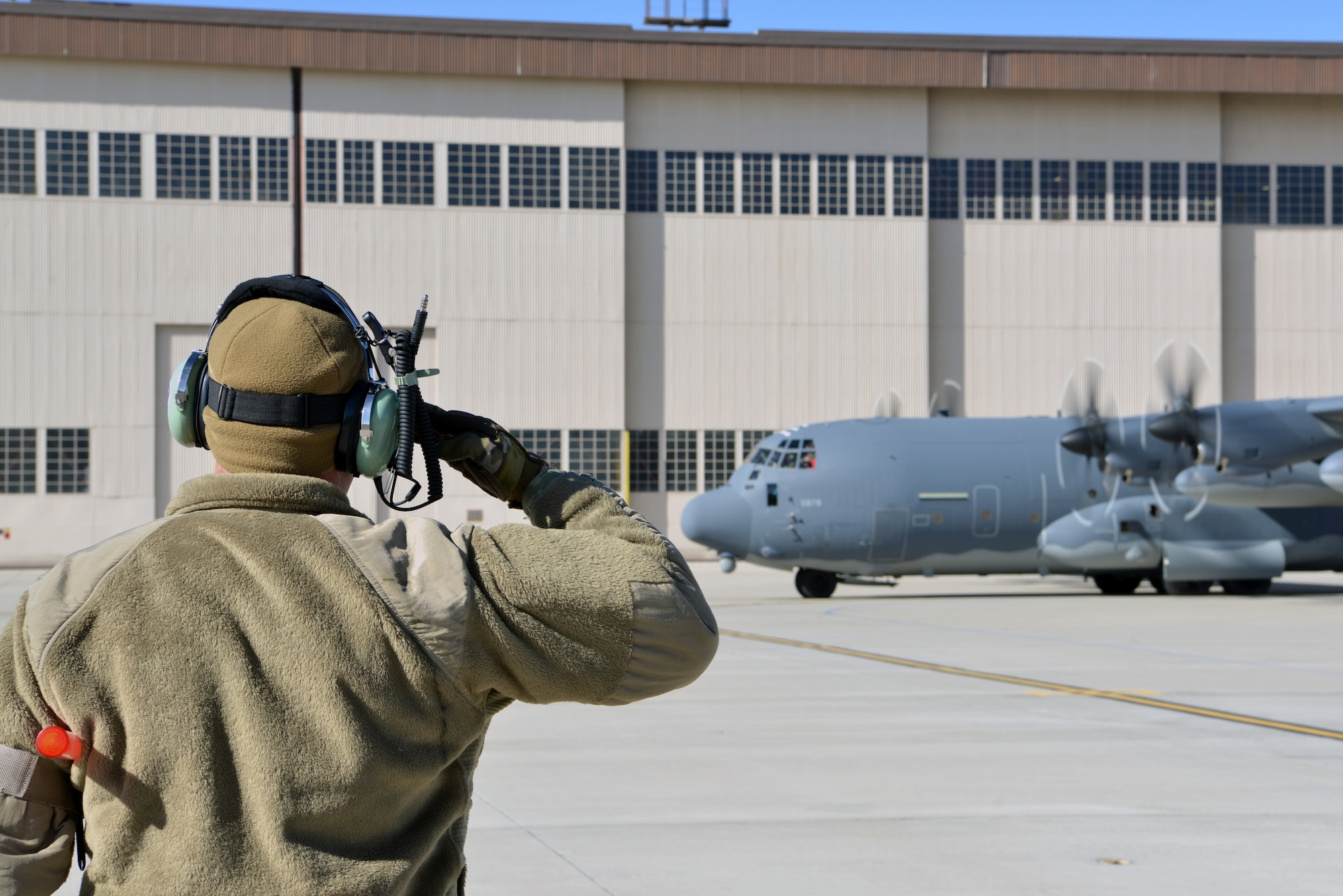 U.S. Air Force Airman 1st Class Paul Hinkle, 415th Aircraft Maintenance Unit crew chief, salutes the pilots of a MC-130J Commando II on the flight line at Kirtland Air Force Base, N.M., Nov. 14, 2019.  The 415 AMU is responsible for all maintenance on the MC-130J Commando II and HC-130J Combat King II aircraft assigned to keep them mission ready for the 415th Special Operation Squadron. (U.S. Air Force photo by Staff Sgt. Dylan Nuckolls)