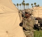 U.S. Army Sgt. Eric Lee, human resources noncommissioned officer (NCO) assigned to the 224th Sustainment Brigade, California Army National Guard, helps to reposition the corner of a deployable rapid assembly shelter (DRASH) tent at Joint Forces Training Base, Los Alamitos, California, March 16, 2019.