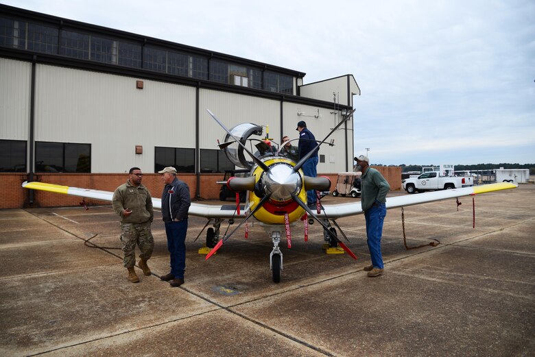 Members of Team BLAZE talk to Retiree Appreciation Day guests in front of a T-6 Texan II Nov. 14, 2019, on Columbus Air Force Base, Miss. During the event, retirees were treated with a free lunch buffet, raffle prizes, a medical expo and free flu shots. (U.S. Air Force photo by Airman 1st Class Jake Jacobsen)