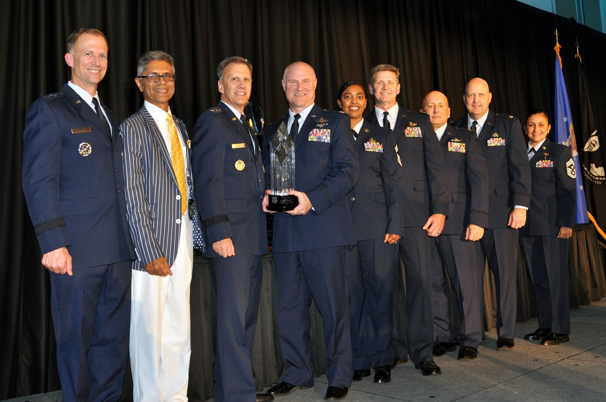 Members from the 507th Air Refueling Wing, Tinker Air Force Base, Okla., accept the 2019 Raincross Trophy, and the title of "Best of the Best in Fourth Air Force," during the 20th Annual Raincross Awards dinner Nov. 19, 2019 at the Riverside Convention Center, Riverside, California. (U.S. Air Force photo by Candy Knight)