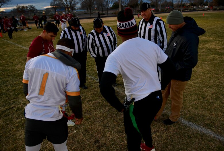 A photo of a coin toss at a football game.