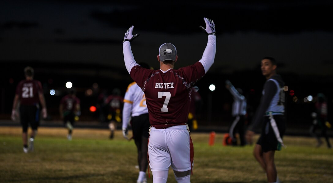 A photo of a football player cheering.