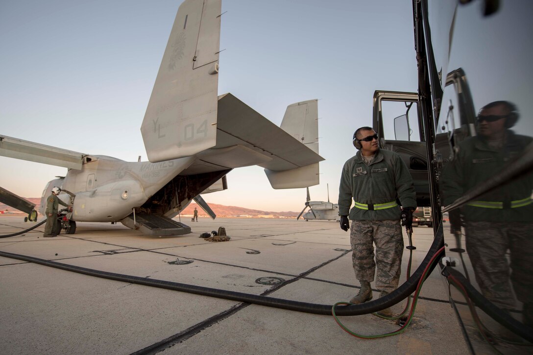 Man refuels aircraft.