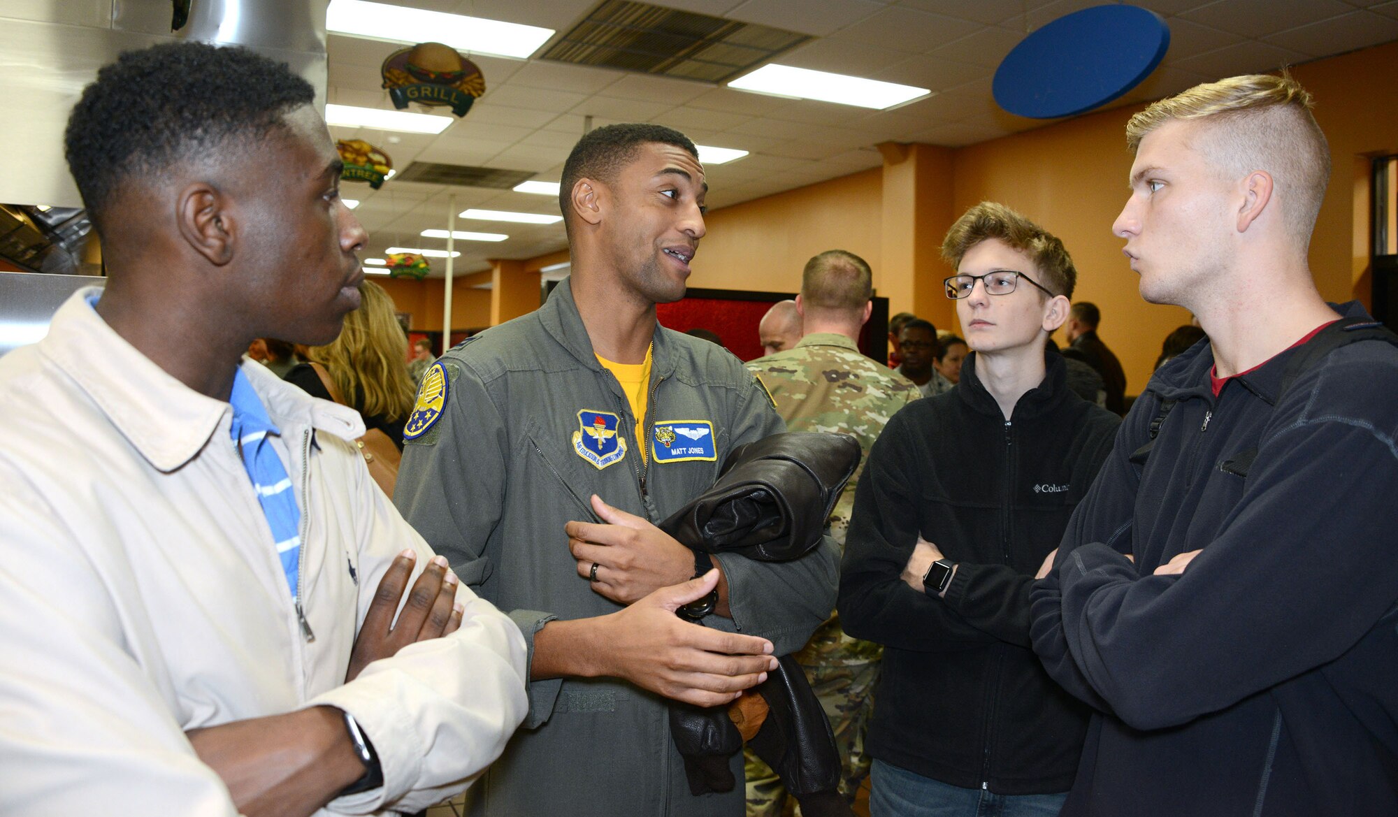 An Air Force mentor talks to students during the Aim High Outreach event at Maxwell Air Force Base, Alabama. Aim High is an Air Force Recruiting Service Detachment 1 sponsored event.