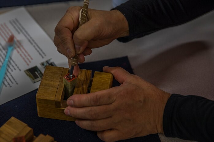 MCAS Iwakuni residents make engraved Tenkoku stamps